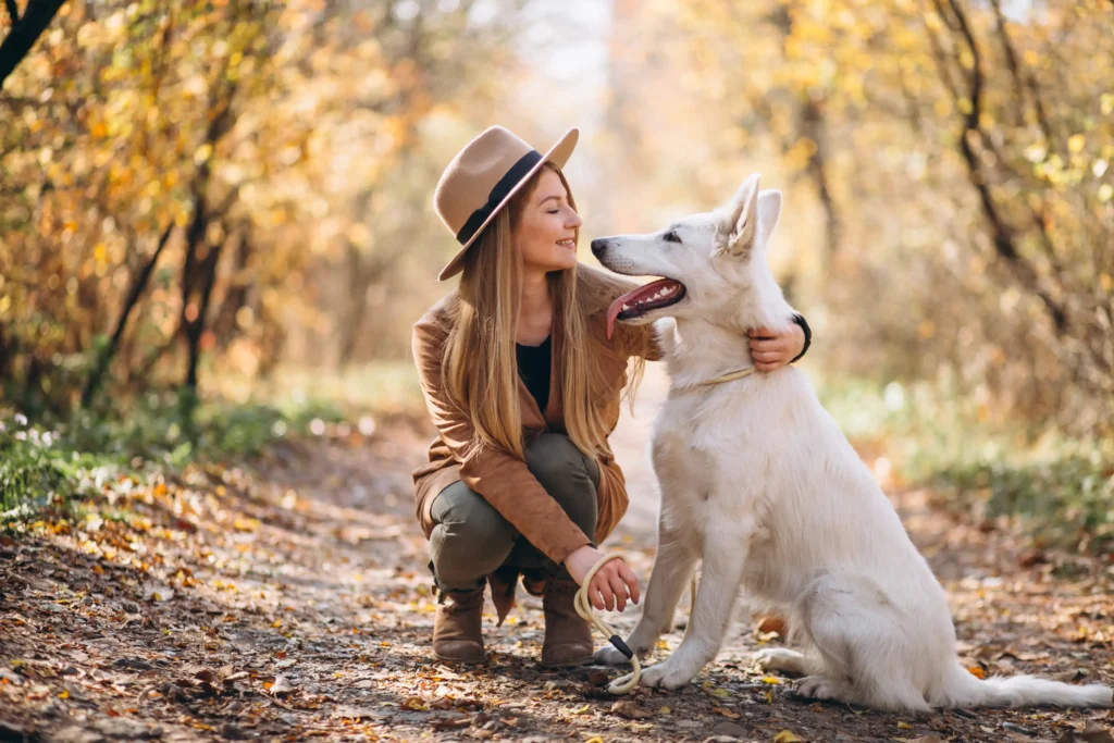 Young woman park with her white dog